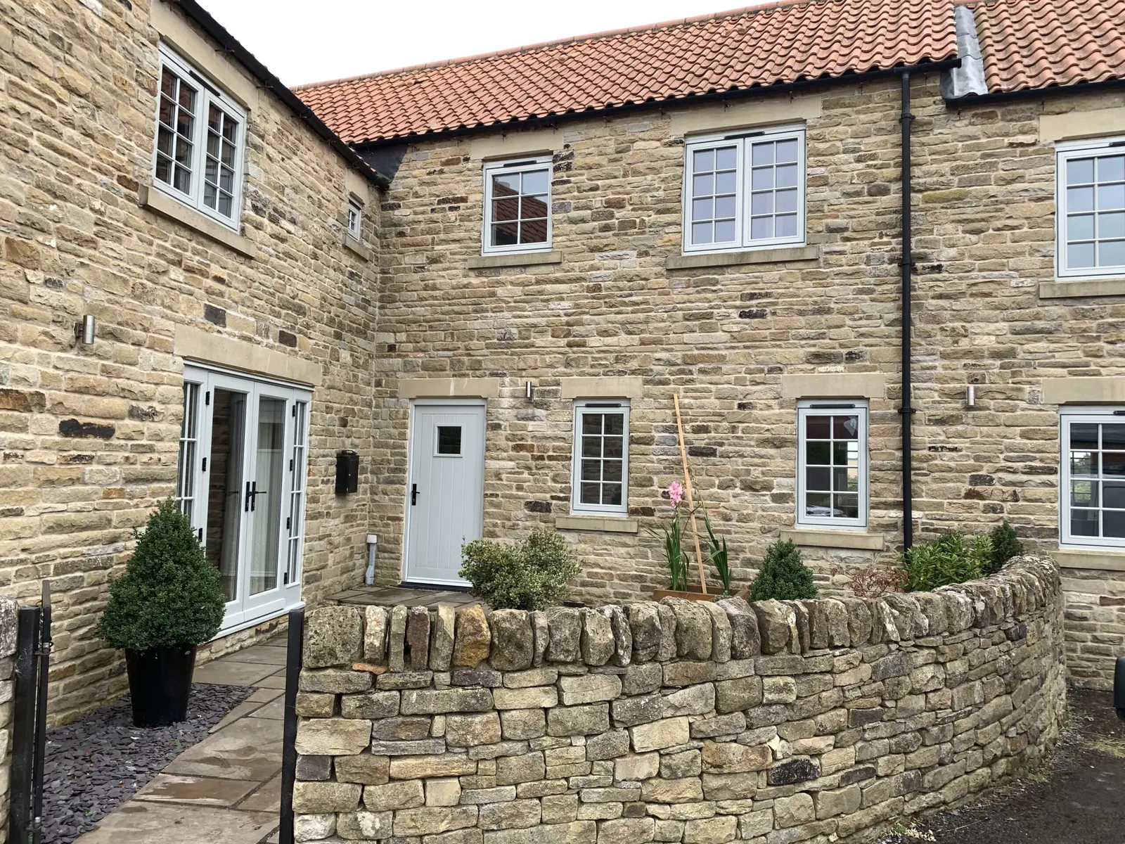 Stone cottage with newly painted white windows and doors